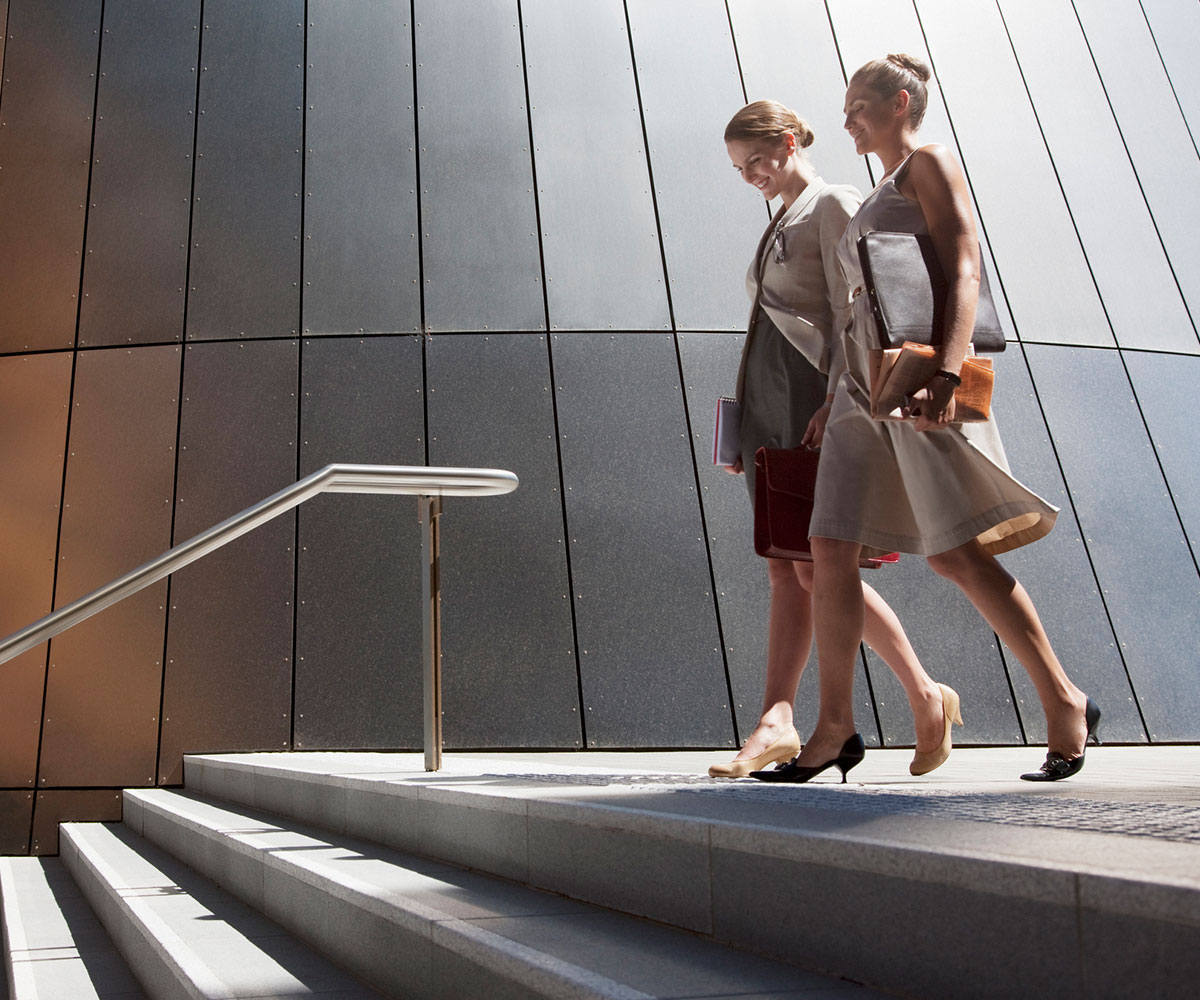 business women walking down steps